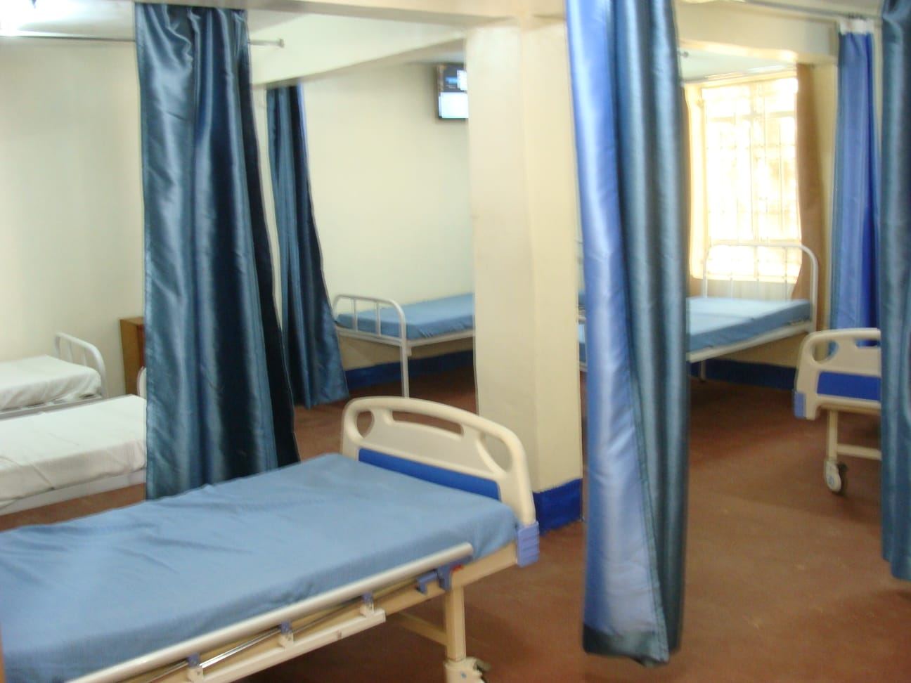 An inpatient ward with curtained bed spaces at SR. Christenem Memorial Hospital